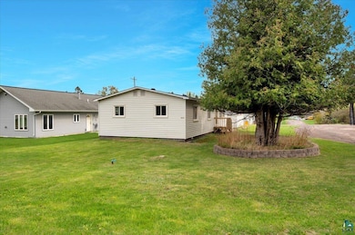 Rear view of house with a lawn