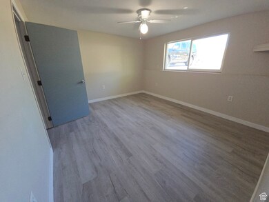 bedroom with light wood-type flooring and a ceiling fan