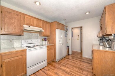 Large bright kitchen has tile counters