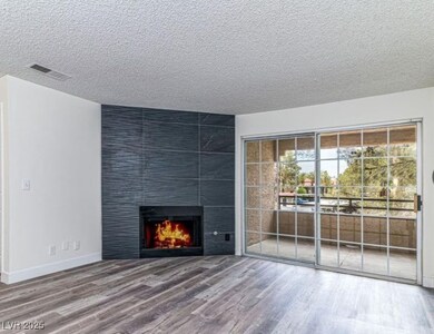 Unfurnished living room featuring wood finished fl