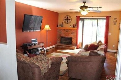 Family Room with fire place and rich flooring thro