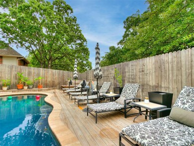 View of pool featuring a wooden deck and a fenced backyard