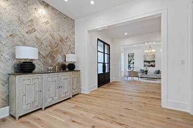 The tile wall is a thoughtful, passthrough from formal living area to dining room