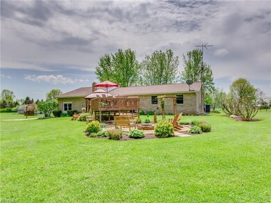 Multi-tiered deck that takes you down to a stone firepit. Beautiful landscaping all around this home!