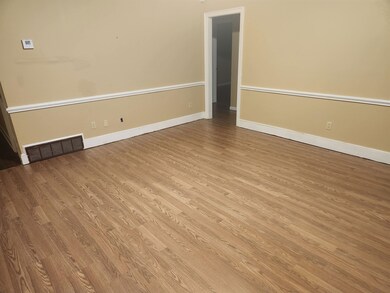 Empty room featuring light hardwood / wood-style f