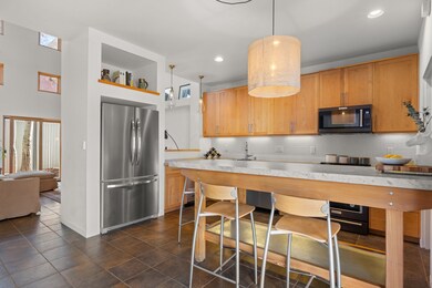 Kitchen with newer appliances and Carrera island