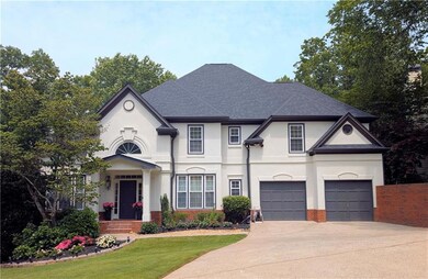 French provincial home with stucco siding, driveway, brick siding, roof with shingles, and an attached garage