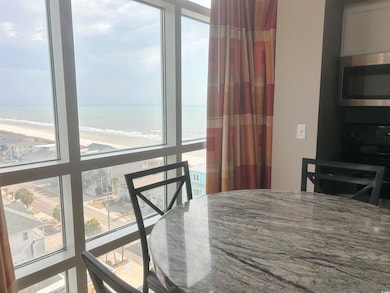 Dining area with a water view and a beach view