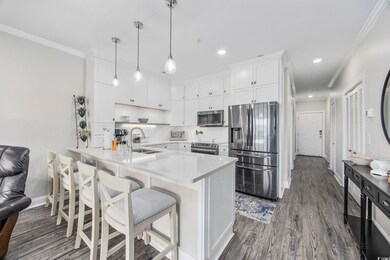Kitchen with dark wood-type flooring, white cabine