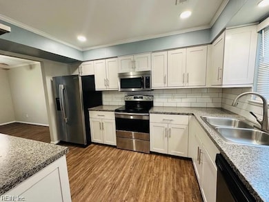 On trend kitchen opens to hall and great room
