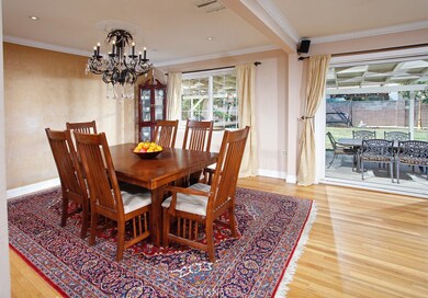 The formal dining room with its glistening picture windows, crown molding, recessed lighting, built-in granite crowned buffet with cabinets and gleaming hardwood is perfect for any occasion.