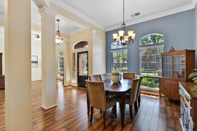 Views of the dining room include crown molding, lovely paint colors, laminate wood flooring and beautiful arched windows.