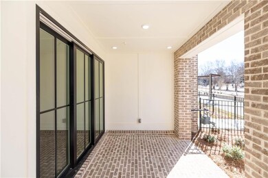 You are greeted with a beautiful covered brick patio.
