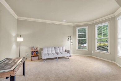 Sitting room with baseboards, carpet floors, crown