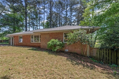 View of property exterior with a yard, fence, and 