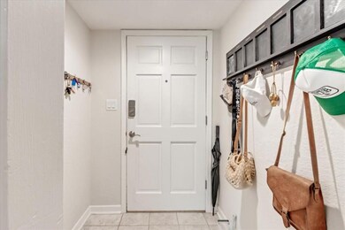 Mudroom with light tile patterned floors and baseboards