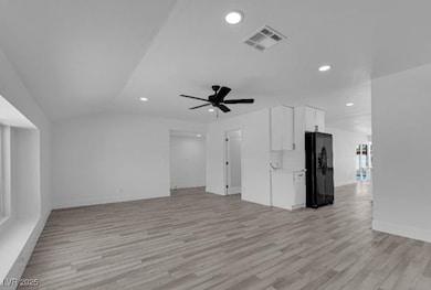 Unfurnished living room featuring light wood-style