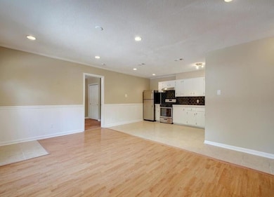 Unfurnished living room with a wainscoted wall, r