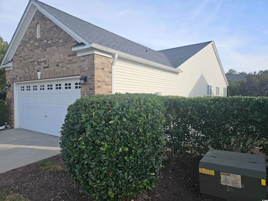 View of home's exterior featuring roof with shingles, driveway, and an attached garage