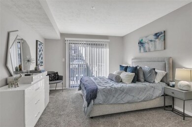 Bedroom featuring light carpet and a textured ceil