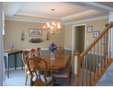 Dining Room. Beautiful upgraded details in the Dining Room include Tray Ceiling, Crown Moulding and Chairrail.