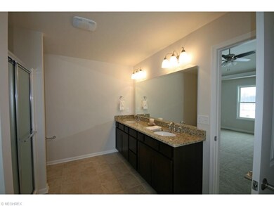 Master bath with long double vanity with granite t