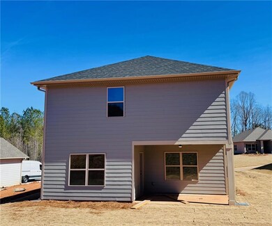 Rear view of house featuring roof with shingles