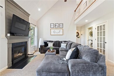 LIVING ROOM HAS FIREPLACE AS A FOCAL POINT.