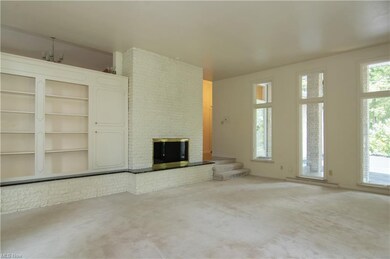 Foyer steps down Living room with fireplace and cu