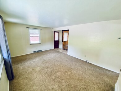 Living room view showing the side entry and kitche