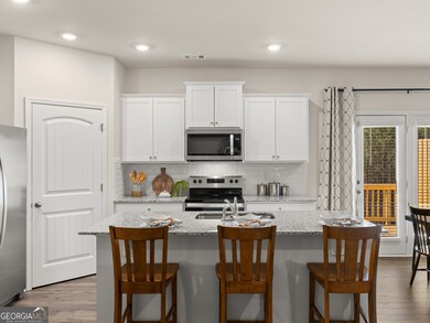 sudbury townhome kitchen with white cabinets and granite countertops at mountain park in dahlonega georgia