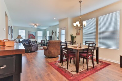 Dining space with wood-type flooring and ceiling f