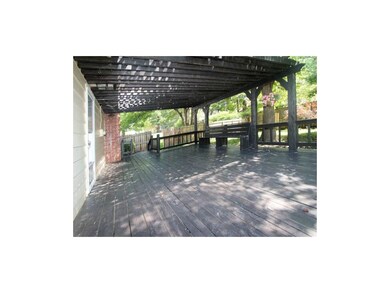 Spacious deck with seating and slatted cover overl