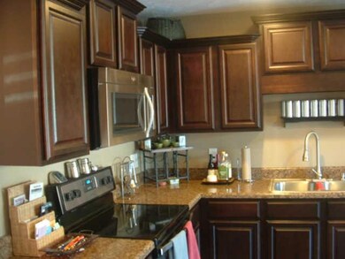 Another look at the Kitchen.  Plenty of cupboards and counter space.  Also a pantry. Hardwood floor.