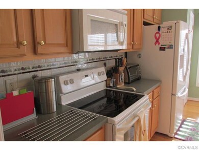 Kitchen features hardwood floors, plenty of counte