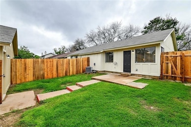 Back of house with a fenced backyard, a patio are