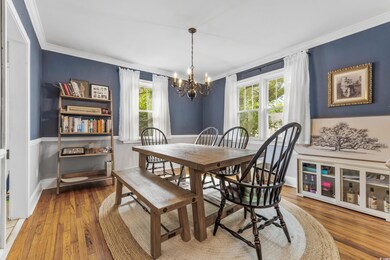 Dining room with an inviting chandelier, hardwood 