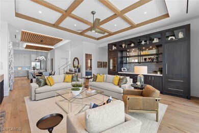 Living room with bar area, coffered ceiling, light