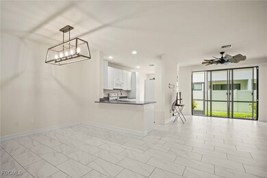 Kitchen with open floor plan, dark countertops, wh