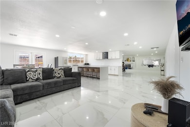 Living area with light marble finish flooring and