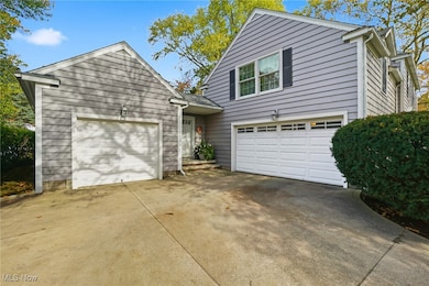 Traditional-style home featuring a garage and concrete driveway
