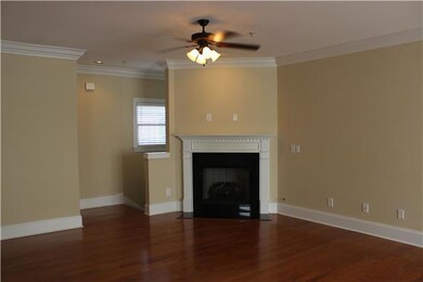 Gleaming Hardwoods Welcome Guests into this Elegant Condo which Features a Gas Fireplace and Beautiful Mantel. 