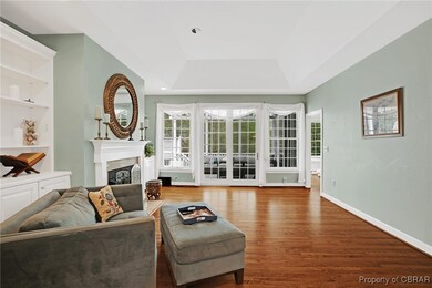 Living area with recessed lighting, a fireplace, b
