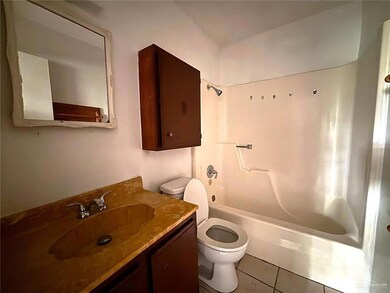 Full bath featuring toilet, vanity, shower / tub combination, and tile patterned flooring