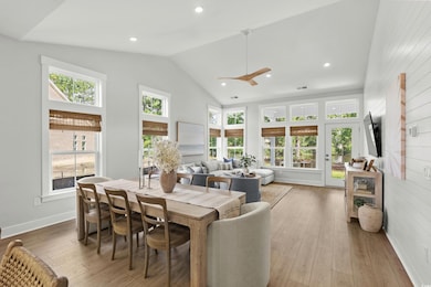 Dining room featuring plenty of natural light, recessed lighting, light wood-style floors, high vaulted ceiling, and ceiling fan