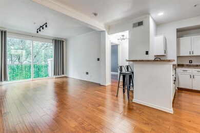 Kitchen with light hardwood floors, white Shaker-s