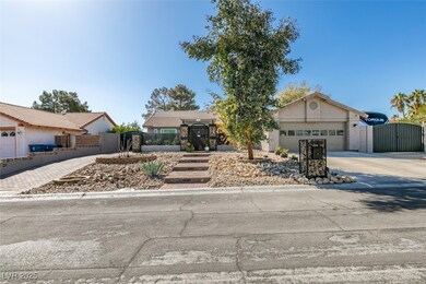 View of front of property with driveway, fence, a