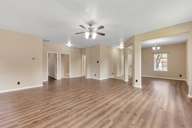 Spacious, open living area with updated vinyl floo