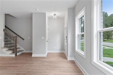 Entryway featuring light wood-style flooring, stai