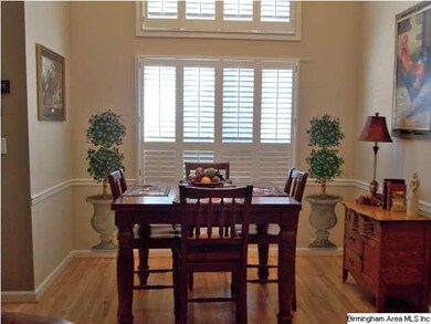 Dining room with painted Topiary beside windows